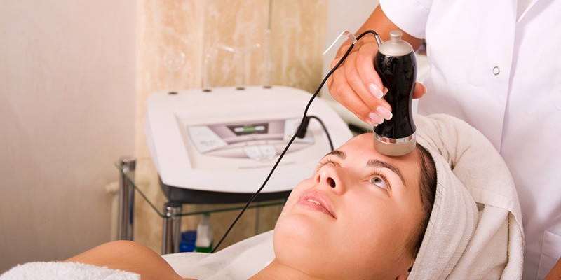 Young woman getting skin cleaning at beauty salon (shallow dof)